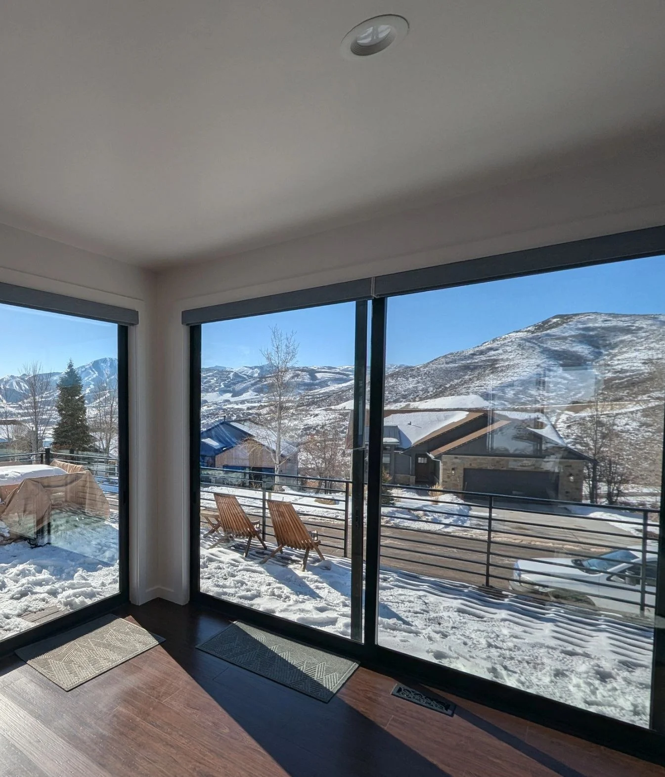 Corner glass wall and hardwood floors looking out to the ski runs
